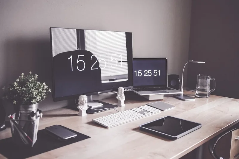 A home office desk with a laptop and monitor, the kind of environment where a local AI stack runs quietly in the background
