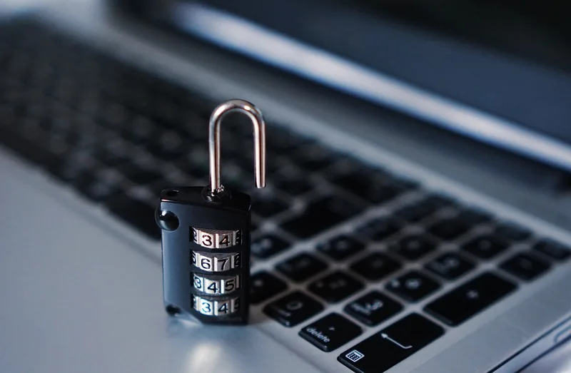 A padlock resting on a computer keyboard, symbolizing data privacy when choosing between local and cloud AI